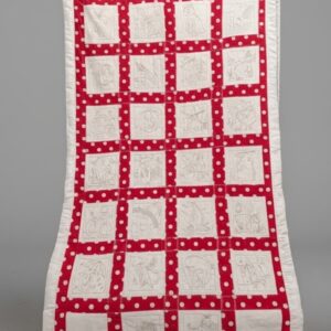 A vertical handmade crib quilt featuring 26 white squares arranged in a grid. Each square contains an embroidered letter of the alphabet and a matching illustration. The squares are separated by bright red sashing with white polka dots and finished with a thick white fabric border.